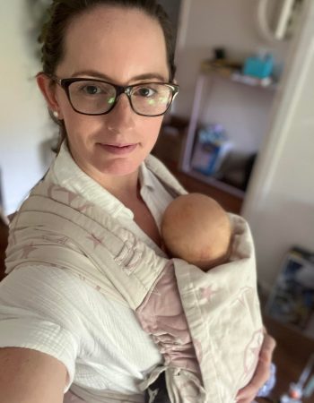 woman babywearing newborn baby