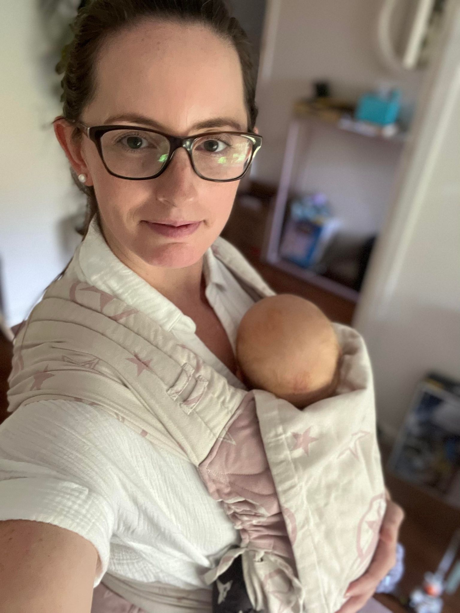 woman babywearing newborn baby